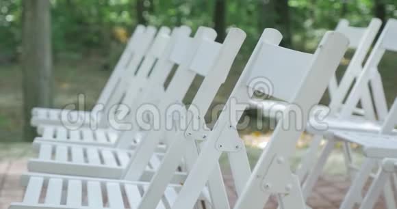 白色结婚椅户外婚礼花园里的婚礼视频的预览图
