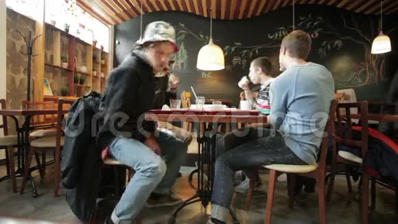 年轻人从桌子上站起来离开咖啡厅视频的预览图