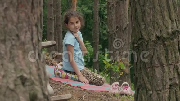 坐在森林里谈慢动作视频的女孩视频的预览图