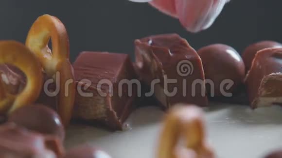 白色奶油蛋糕巧克力糖霜巧克力和椒盐卷饼糕点视频的预览图