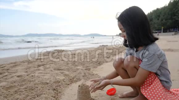 慢动作亚洲小女孩在海滩上玩耍视频的预览图