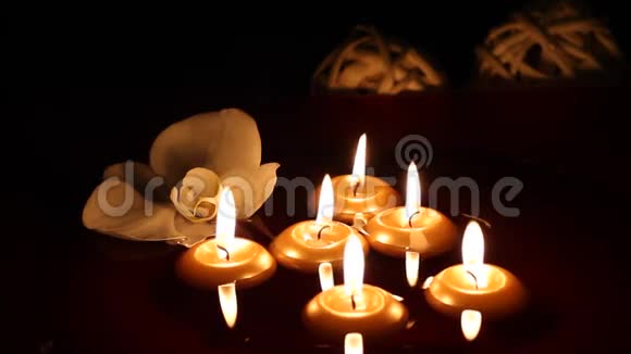 漂浮的蜡烛和兰花在黑暗中视频的预览图