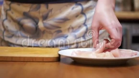 女人烹制的新鲜生肉在餐桌上与肉锤在家庭厨房慢动作视频的预览图