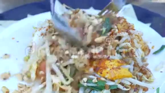 吃泰国炒米粉配上鸡蛋和蔬菜视频的预览图