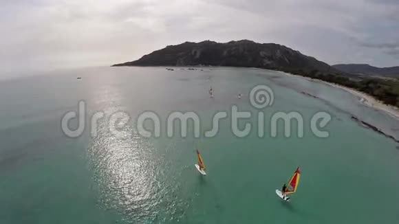 在法国科西嘉圣朱利亚海滩与冲浪者飞越海湾空中观景视频的预览图