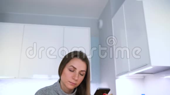 女人在家里用信用卡和智能手机在线支付视频的预览图