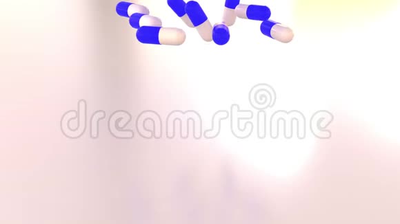 蓝色和白色药物胶囊或药片散落在桌子上视频的预览图