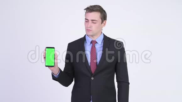 年轻快乐英俊的商人带着电话和大拇指视频的预览图