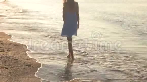 在海滨散步的年轻女子视频的预览图