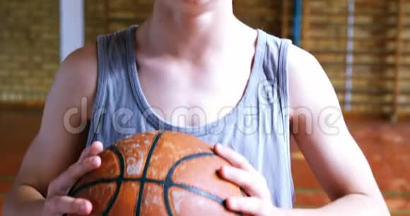 站在球场上打篮球的男生视频的预览图