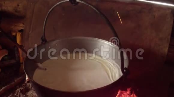 发酵牛奶在一个大锅中煮沸从上面的火焰特写视图视频的预览图