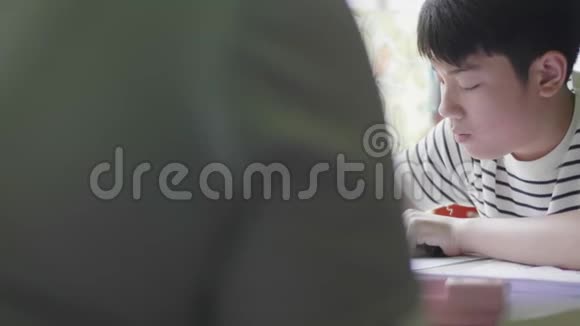 亚洲男孩用平板电脑做作业视频的预览图