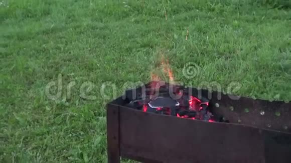 烤架里的人把煤吹到着火视频的预览图