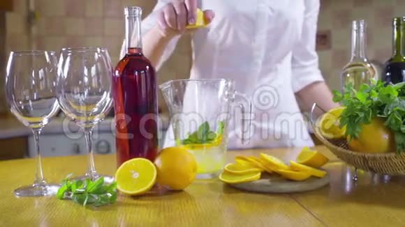 女人挤着橘子做鸡尾酒慢动作视频的预览图