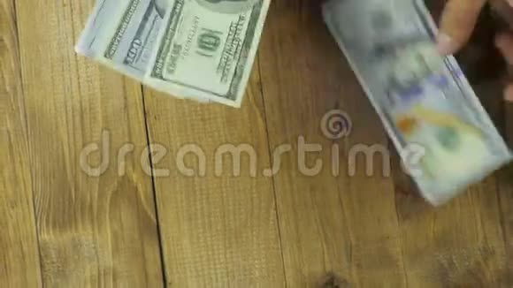 美元钞票落在木桌上视频的预览图