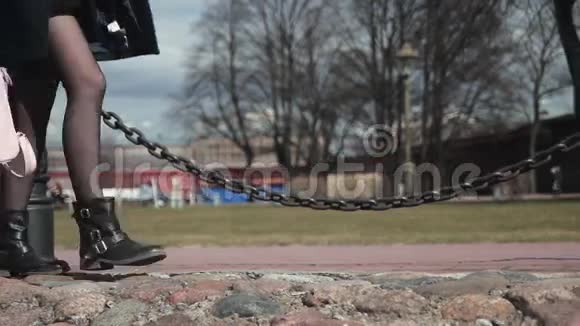 穿着黑鞋在公园里散步的女孩的腿视频的预览图