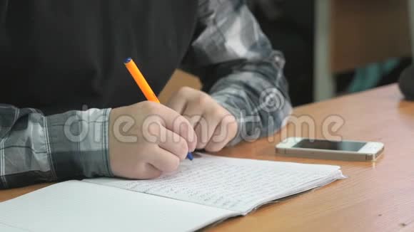 不知名的学生用钢笔在笔记本上写课文视频的预览图