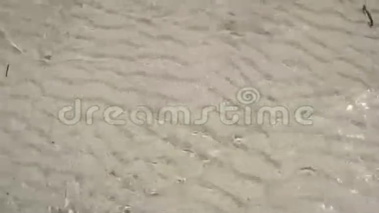 薄薄的一层水在沙子里闪闪发光背景视频的预览图