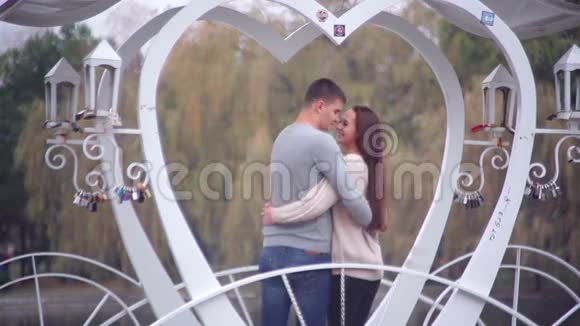 可爱的一对夫妇站在凉亭里以心脏的形式视频的预览图