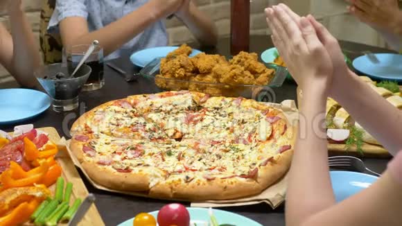 一家人在舒适的家庭环境中吃饭自制食物自制披萨快乐的一家人一起吃午饭坐在一起视频的预览图