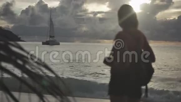 日落时年轻女子的剪影后景视频的预览图