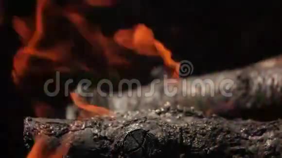 樱桃木的树枝堆在烧烤炉里燃烧着鲜红的火焰视频的预览图
