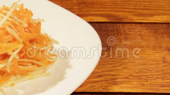 木制背景上胡萝卜和卷心菜的蔬菜沙拉视频的预览图
