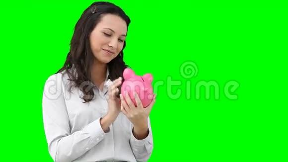 女人把钱放进她的储蓄罐里视频的预览图