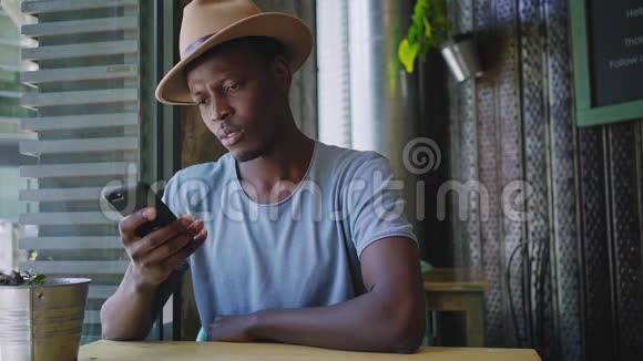 年轻的黑人坐在时髦的咖啡馆里视频的预览图