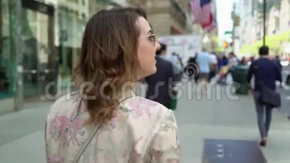 在城市里散步的年轻女人视频的预览图