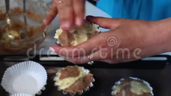 那个女人把面团放进烘焙模具里把面团凝结成烤盘大理石蛋糕的准备视频的预览图