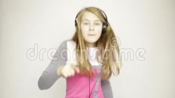 少女听耳机音乐和有趣的舞蹈视频的预览图
