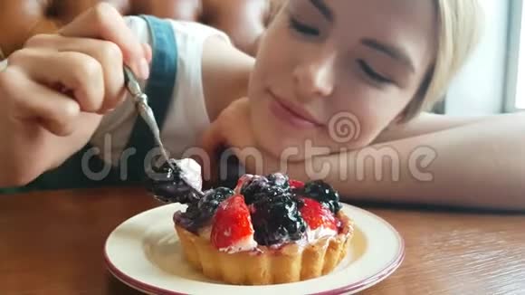 年轻女人吃黑莓蛋糕视频的预览图