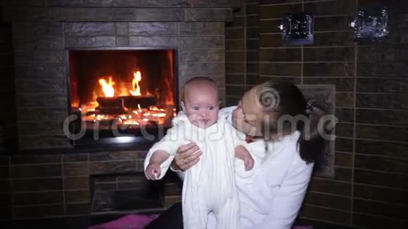 圣诞节的时候妈妈和孩子坐在壁炉旁视频的预览图