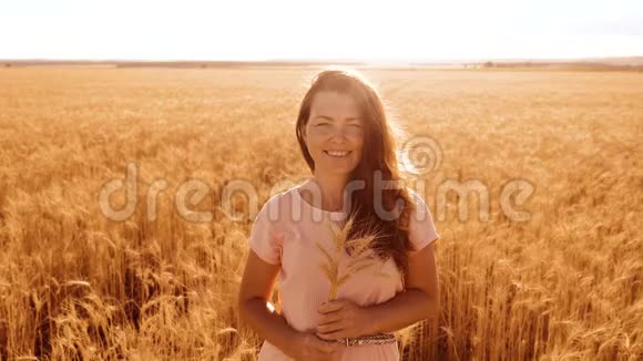 肖像美女微笑女孩时尚模特在慢动作视频白色连衣裙在田间小麦妇女视频的预览图