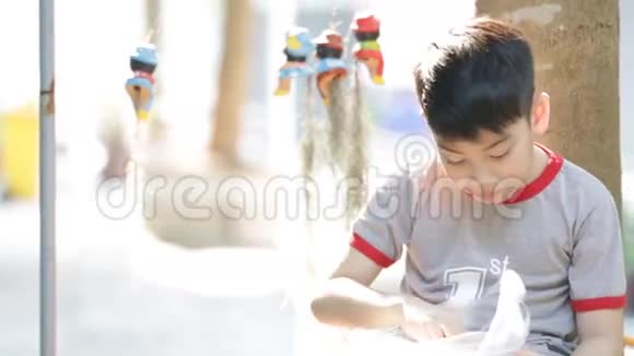 小亚裔男孩在家吃零食视频的预览图
