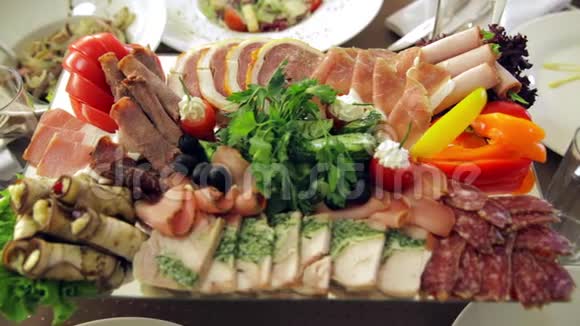 宴会桌上有水果鱼和肉的菜肴视频的预览图