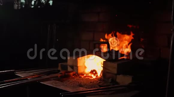 一个铁匠把炉子的火焰扇起来用这些工具可以防止余烬火花在炉边飞舞视频的预览图