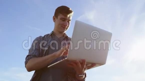 一个在海岸带笔记本电脑的年轻美女视频的预览图