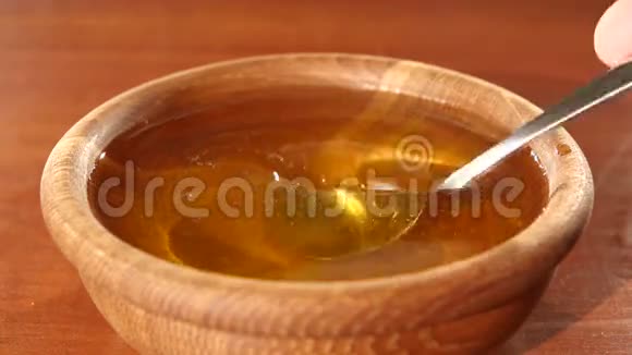 用汤匙在木碗里取蜂蜜视频的预览图