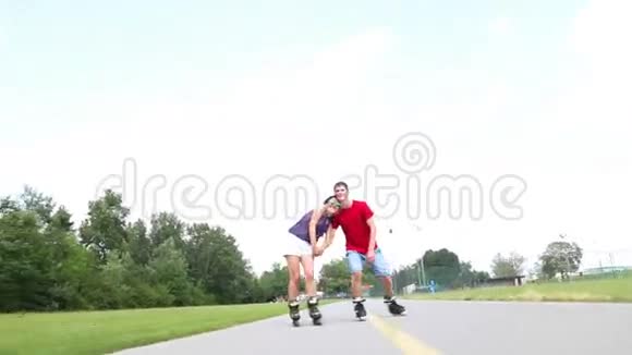 年轻的女人和男人在一个美丽的温暖的日子里在公园里滑行和表演视频的预览图