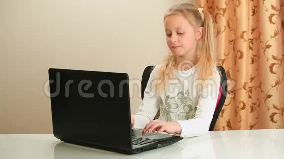 年轻女孩坐在椅子上用笔记本电脑视频的预览图