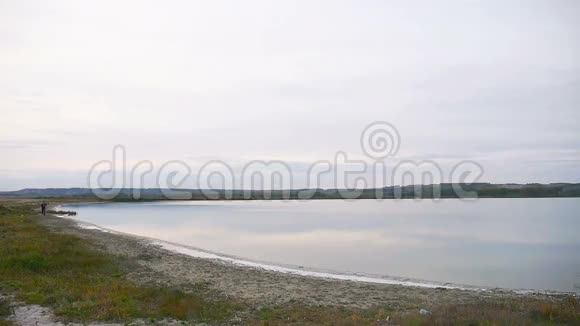 男子运动员在湖泊附近的自然环境中进行跑步运动视频的预览图