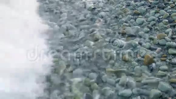 海滩卵石上的海浪视频的预览图