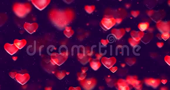 抽象的多色渐变红色和紫色渐变背景bokeh闪光和红色心形流动情人节视频的预览图