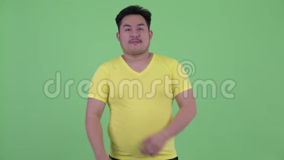 快乐的年轻超重的亚洲男人双臂交叉微笑视频的预览图