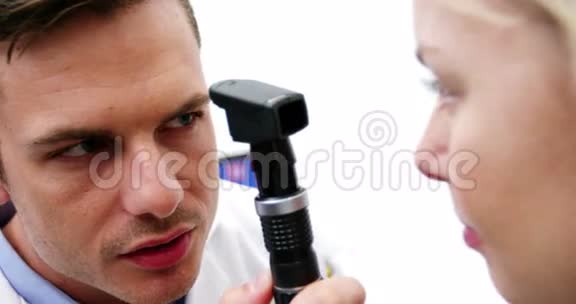 验光师通过检眼镜检查女性患者视频的预览图