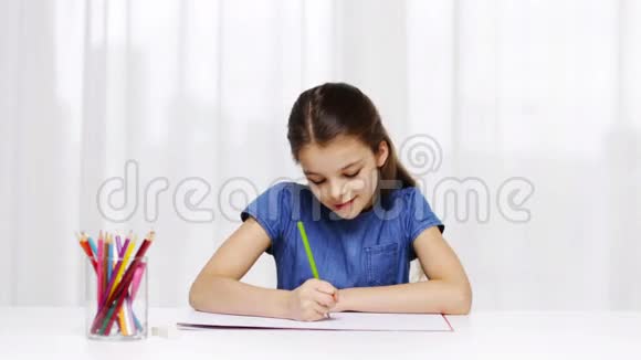 快乐的女孩在家用彩色铅笔画画视频的预览图