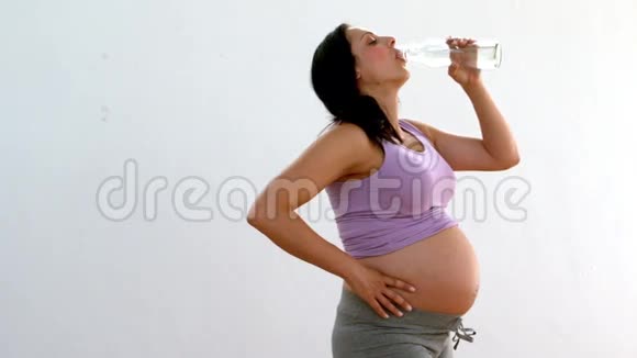 怀孕的黑发女人喝水视频的预览图
