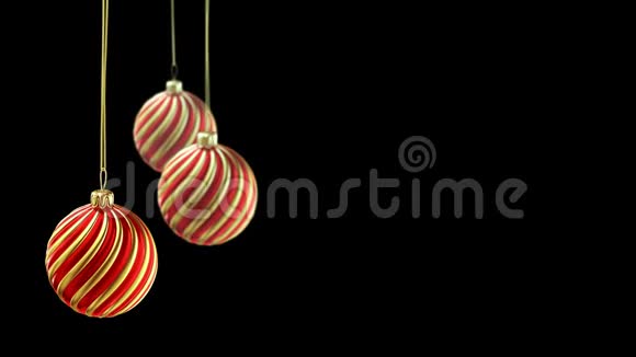 三个圣诞球挂在黑色背景的丝带上4K视频的预览图